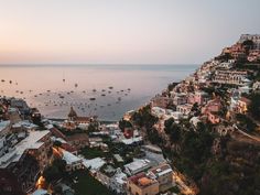 an aerial view of boats in the water and buildings on both sides of the bay