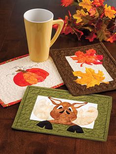 three placemats with pictures of animals on them and autumn leaves in the background