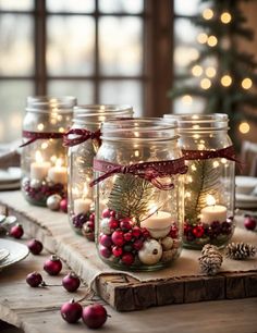 mason jars filled with christmas decorations and lit candles