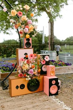 an assortment of speakers and flowers on display