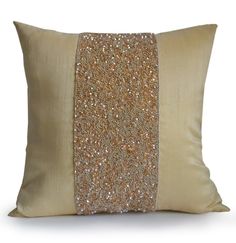 a gold pillow with sequins on the front and back, sitting against a white background