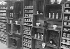 an old store filled with lots of jars and containers on shelves next to each other