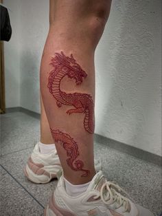 a person with a dragon tattoo on their leg