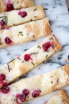 cranberry and rosemary bread sticks on a marble counter