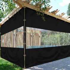 an outdoor gazebo with black fabric covering it