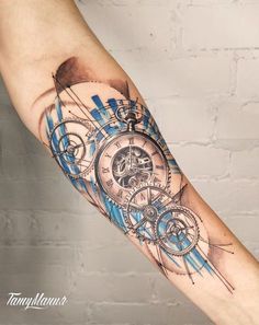 a man's arm with a blue and black clock tattoo on the left forearm