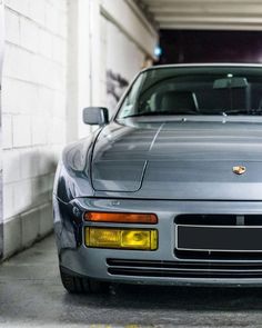 a silver sports car parked in a garage