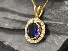 Gold Sapphire Pendant set with a Created Sapphire in a diamond cut, flawless clarity & Royal blue color, at 10x8mm, 3 Carats. Surrounded by small CZ Diamonds. Antique Pendant design made of Gold Vermeil ☞ thickest 18k Gold Plating on top of Solid 925 Sterling Silver ☞ made to last. Matching Ring: www.etsy.com/listing/774958233 Matching Earrings: www.etsy.com/uk/listing/776293819    Details :  ♥ Each item comes in a cute GIFT BOX ✓ ♥ GUARANTEE on the materials ✓ ♥ Created Sapphire - diamond cut, Blue Sapphire Pendant, Matching Ring, Antique Pendant, Real Jewelry, Blue Pendant, Sapphire Pendant, Royal Blue Color, Matching Rings, Necklace Blue