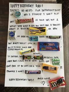 a birthday card with candy on it and some words written in the paper next to it