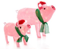 two pink pigs wearing scarves and scarfs with lights on their backs, standing next to each other