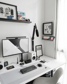 a white desk topped with a computer monitor and keyboard