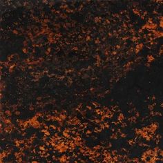 an orange and black marble textured with dark brown highlights on the surface, as seen from above