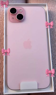 an iphone case with pink bows on it