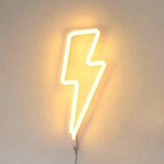 a neon sign with a lightening bolt on it's side in front of a white wall