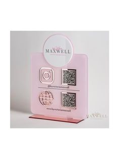 a pink box with some metal objects in it's display stand on a white surface