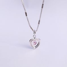 Introducing our Pink Glam Heart Necklace - crafted in Sterling Silver with a heart-shaped pink crystal at its core. This unique chain necklace features a sparkling pink crystal heart pendant, on a Sterling Silver heart shape base adding sophistication to any look. Wear it long or short with the adjustable clasp. Elevate your style with this enchanting piece that radiates love and glamour. Main Stone: heart shaped lab diamond Stone Color: pink Metal Material: 925 Sterling Silver Chain Lenght: 16 Silver Heart-shaped Crystal Necklace With Clavicle Chain, Pink Crystal Heart Pendant Jewelry, Crystal Heart Cut Necklace With Heart Charm, Pink Crystal Heart Pendant Necklace, Pink Heart-shaped Jewelry With Clavicle Chain, Pink Heart-shaped Clavicle Chain Jewelry, Silver Heart Cut Crystal Necklace For Valentine's Day, Heart Shaped Crystal Jewelry With Adjustable Chain, Heart Shaped Crystal Necklace With Adjustable Chain