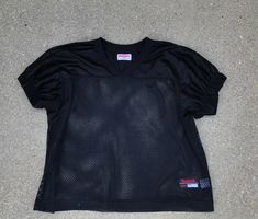 a women's black shirt laying on the ground