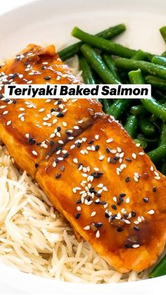 a white bowl filled with rice, green beans and salmon on top of sesame seeds