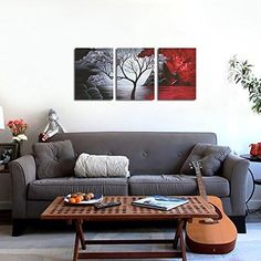 a living room with couches, tables and paintings on the wall in it's center