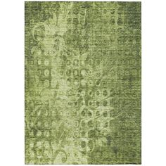 a green rug with an intricate design on the front and back side, in various colors