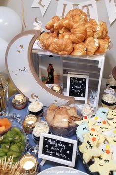 a table topped with lots of food and desserts