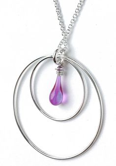 This necklace of glittering circles and a single vibrant drop of sun-melted glass is just the thing to celebrate the changing of the celestial seasons. Dangling from a recycled sterling silver chain, a dainty drop of color is framed in circles of sparkling silver, with each element swinging freely. Whether you like to match or contrast with your favorite outfit, one of these shining colors will be just your cup of tea! Pendant length: 1 1/2" (4 cm) Eco-friendly jewelry, made from sun-melted recy Modern Nickel-free Teardrop Pendant Jewelry, Nickel-free Drop Sterling Silver Necklace, Handmade Sterling Silver Drop Necklace, Sterling Silver Drop Necklace Nickel Free, Handmade Sterling Silver Dangle Drop Necklace, Silver Sterling Silver Round Drop Necklace, Nickel Free Sterling Silver Drop Necklace, Silver Teardrop Birthstone Drop Necklace, Silver Birthstone Drop Necklace