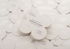 many white circular coasters are arranged on top of each other with the words forever clover printed on them