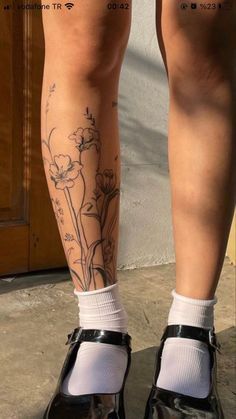 the legs and ankles of a woman with tattoos