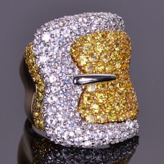 Fun, unique and elegant! This ring is masterfully made in 14k white and yellow gold, and is set with over 5.5 carats of vibrant white and yellow sapphires. Custom Ring Dish, Polymer Clay Ring, Buckle Ring, Beautiful Belts, Large Jewelry, Pave Ring, Jewelry Dish, Mellow Yellow, Yellow Sapphire