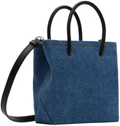 Denim top handle bag in blue. · Fading and leather trim throughout · Fixed carry handles · Detachable and adjustable pin-buckle crossbody strap · Logo embossed at face · Card slot at interior · Twill lining · Logo-engraved silver-tone hardware · Contrast stitching in tan · H6.5 x W6.25 x D2.75 Supplier color: Multi blue Casual Top Handle Denim Shoulder Bag, Denim Top Handle Shoulder Bag For Shopping, Blue Denim Top Handle Shoulder Bag, Denim Shoulder Bag With Top Handle, Denim Shoulder Bag With Top Carry Handle, Blue Shoulder Bag With Top Round Handle, Denim Blue Leather Bag, Rectangular Shape, Denim Blue Leather Rectangular Bag, Denim Bags With Detachable Handle For Daily Use