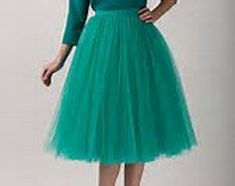 This Gorgeous and Feminine Tulle skirt can be made in ANY color, ANY length, and any size. This beautiful skirt is the ideal Bridesmaid Dress or Wedding Skirt and is lined with a soft satin fabric of the same or contrasting color as the tulle. ALL ITEMS HANDMADE BY ME IN USA The satin waistband is flat with zipper and hook/eye closure in back. Elastic can be added to the back of the waistband, however only allows for a little wiggle room. These custom tutu skirts are perfect for any occasion and Formal Fitted Tulle Skirt, Elegant Fitted Petticoat For Prom, Green A-line Dress With Lined Skirt, Knee-length Wedding Skirt, Fitted Tulle Dress With Lined Skirt, Fitted Green Petticoat For Spring, Green Wedding Skirt For Spring, Green Spring Wedding Skirt, Fitted Skirt For Spring Bridesmaid