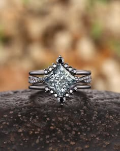 a diamond ring sitting on top of a rock