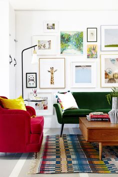 a living room filled with colorful furniture and pictures on the wall above it's coffee table