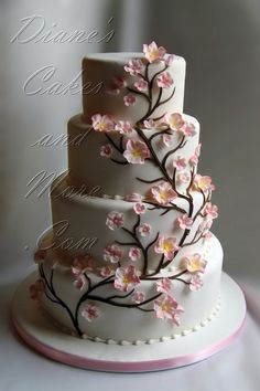 a three tiered cake with pink flowers on it