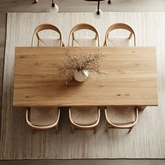 an overhead view of a dining room table with chairs and a vase on the table