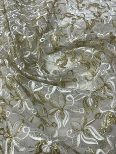 "Content: 100% polyester Organza embroidered lace mix with white and gold This fabric is beautiful and it is perfect for dresses, skit, tops, draping, and more Width: 45/47\" price per yard" Party Cream Embroidered Fabric With Floral Design, Cream Embroidered Fabric With Floral Design For Party, Elegant White Embroidered Fabric For Celebrations, Gold Fitted Floral Embroidered Dupatta, White Lace For Spring Party, Cream Resham Embroidered Fabric For Party, Festive Spring Dupatta With Lace Work, Fitted Gold Dupatta With Floral Embroidery, Gold Dupatta With Floral Embroidery