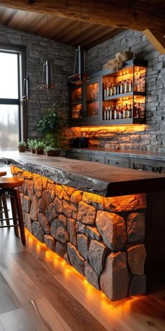 a stone bar is lit up with orange lights