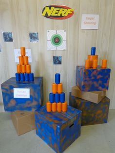 two boxes are stacked on top of each other with orange and blue cups in them