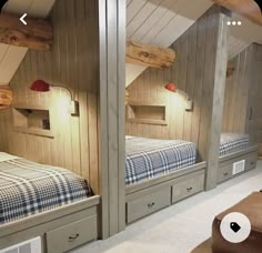 there are two beds in the room with wooden walls