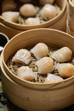 some food is sitting in bamboo bowls on the table