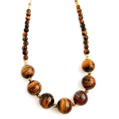 Very pretty golden Tiger's eye necklace. Large round Tiger's eye stone beads that measure about   inches with accent gold metal beads in between, & faceted Tiger's eye stone beads along the ends. This necklace measures about 23.75 inches in length & can be shortened if desired. (Please see the different length options for this necklace). Natural colors & swirl patterns in these stone beads. Shades of gold & brown, perfect for Fall! Gold Rondelle Beaded Necklace With Natural Stones, Gold Natural Stones Round Beads, Gold Round Beads With Natural Stones, Brown Faceted Bead Necklaces, Brown Faceted Round Bead Necklaces, Gold Gemstone Round Beads, Gold Crystal Necklace With Large Round Beads, Stone Beads Necklace, Golden Tiger