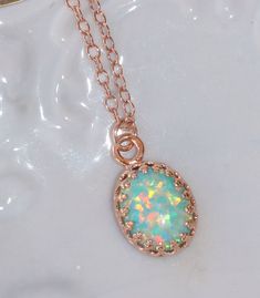 "A lovely necklace made using 14K rose gold filled components and a white opal. The opal is oval in shape and has flashes of pinks, greens, blues and so much more with every turn of the stone! It is my favorite color opal and is a lovely shade of mint green. It's been hand-set into a premium 14K rose gold plated brass crown setting. The pendant hangs from 14k rose gold filled chain. Necklace closes with a gold filled clasp. Opal measures 10mm long (just shy of 1/2\"). Please choose desired chain Rose Gold Crown, Swarovski Crystal Jewelry, Green Opal, Gold Crown, Lovely Necklace, Opal Pendants, Opal Necklace, Natural Opal, White Opal