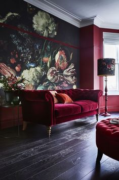 a living room filled with furniture and a painting on the wall