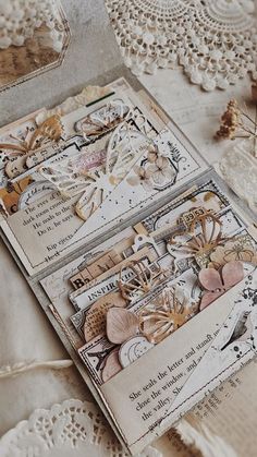 an open book with doily and lace on it