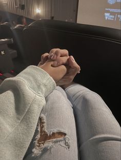 a person sitting in an auditorium holding their hands together