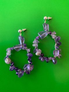 "Smooth and faceted Amethyst stones in various sizes wrapped on sterling silver hoop. Length 3\" Hoop 1 3/4\" wide" Purple Amethyst Gemstone Chandelier Earrings, Purple Dangle Hoop Earrings, Purple Amethyst Hoop Jewelry, Statement Chandelier, Hoop Dangle Earrings, Statement Chandeliers, Amethyst Stones, Sterling Silver Hoops, Amethyst Stone