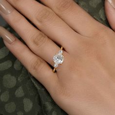 a woman's hand with a diamond ring on it