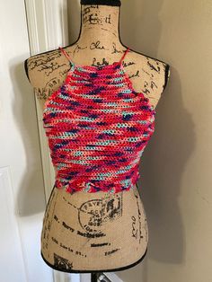 This is a multi-colored crocheted summer top. Handcrafted.  Ties behind the neck and across the back.  Adjustable to fit you. Size: Small Colorful Fitted Tops For Summer, Multicolor Sleeveless Crochet Top For Beach, Colorful Sleeveless Beach Top, Colorful Sleeveless Top For Beach, Multicolor Stretch Tank Top For The Beach, Colorful Fitted Tops For Beach, Fitted Multicolor Tops For Beach Season, Casual Fitted Multicolor Halter Top, Stretch Casual Crochet Halter Neck Top