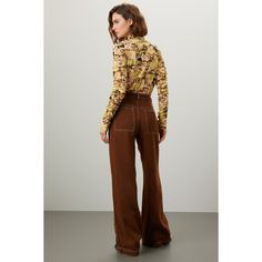 Brown cotton (55% Polyester, 45% VIscose). Pants. Front zipper fly with button closure. 32" inseam. 10" rise. Imported. Retro Trousers Jeans For Fall, Retro Jeans Shaped As Trousers For Fall, Brown Five-pocket Pants For Fall, Brown Pants With Five Pockets For Fall, Fall Workwear Bottoms With Button Zip Fly, Retro Wide Leg Bottoms For Fall, Brown Pants With Button Closure For Fall, Fall Brown Pants With Button Closure, Trendy Fall Bottoms With Button Zip Fly