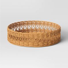 a round wicker basket with no handles on the bottom and one section in the middle